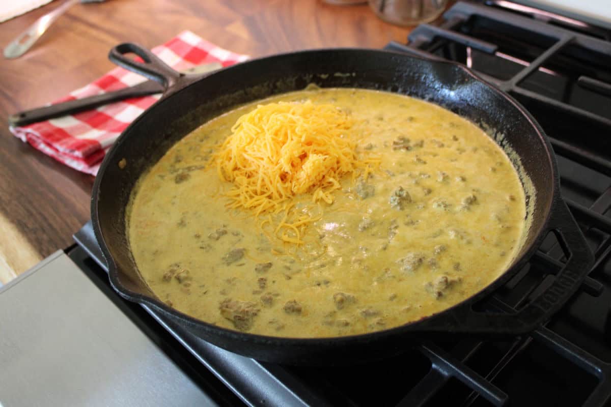 grated cheese in a creamy beef sauce