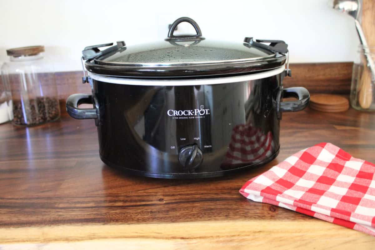 black crockpot on wood countertop
