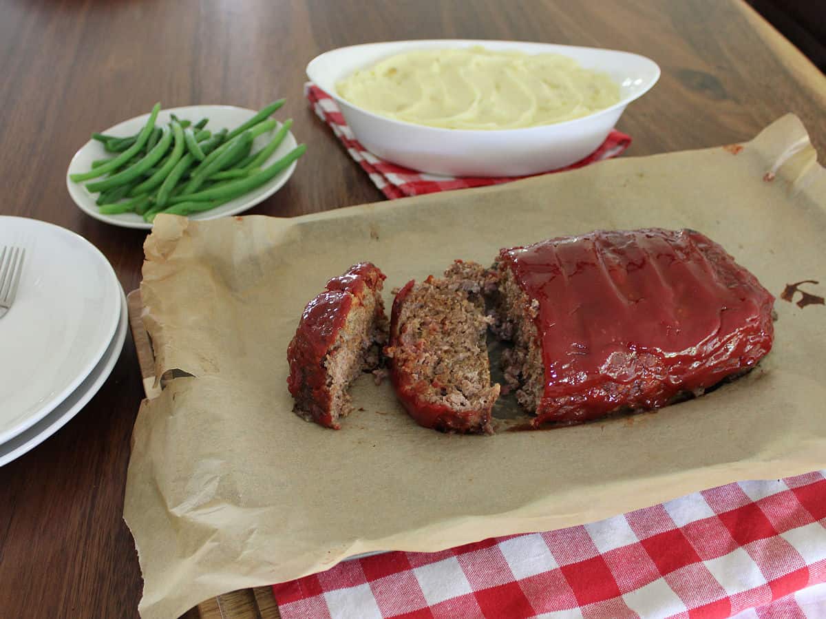 sliced meatloaf on a parchment paper lined cookie sheet