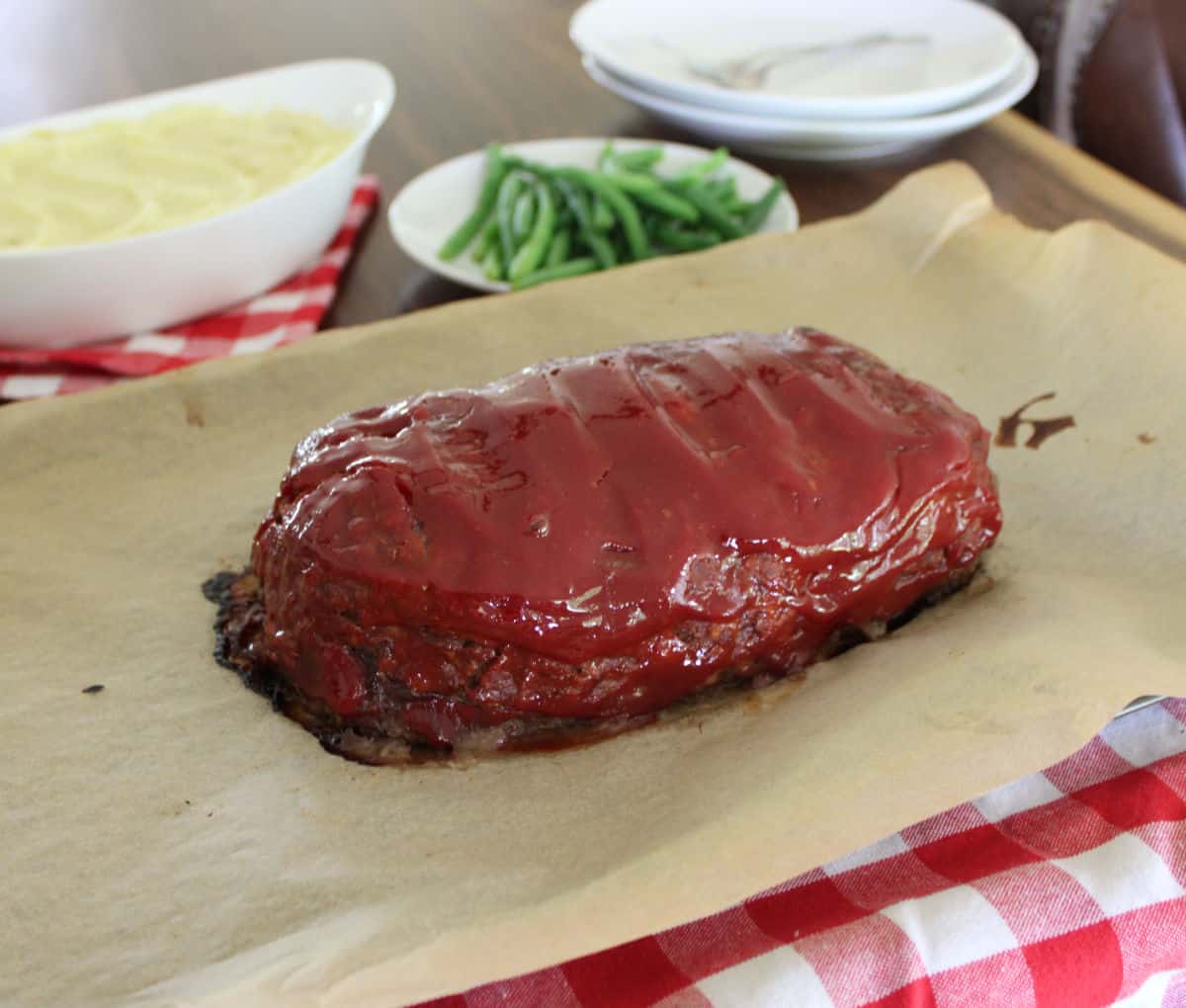 old fashioned meatloaf on a parchment paper lined cookie sheet