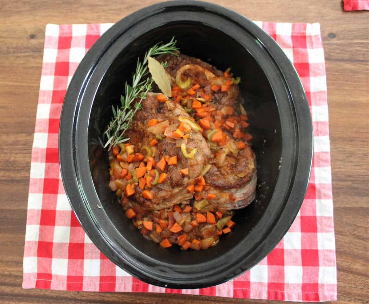 beef shanks and and diced sauteed vegetables in a crock pot