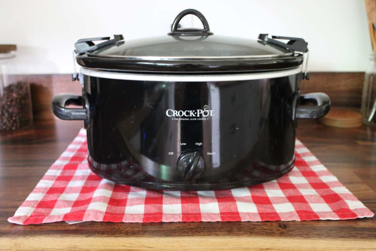 black crock pot on a wood counter top