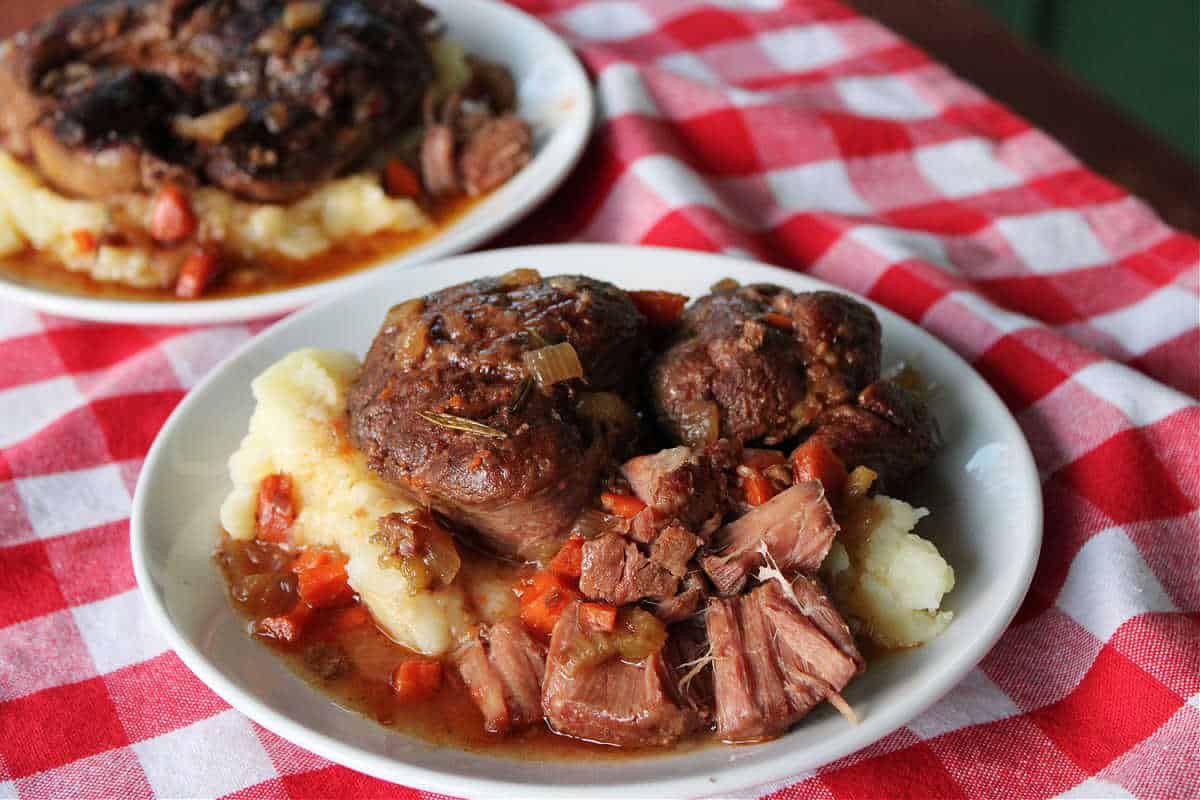 slow cooker Osso Buco served on mashed potatoes.