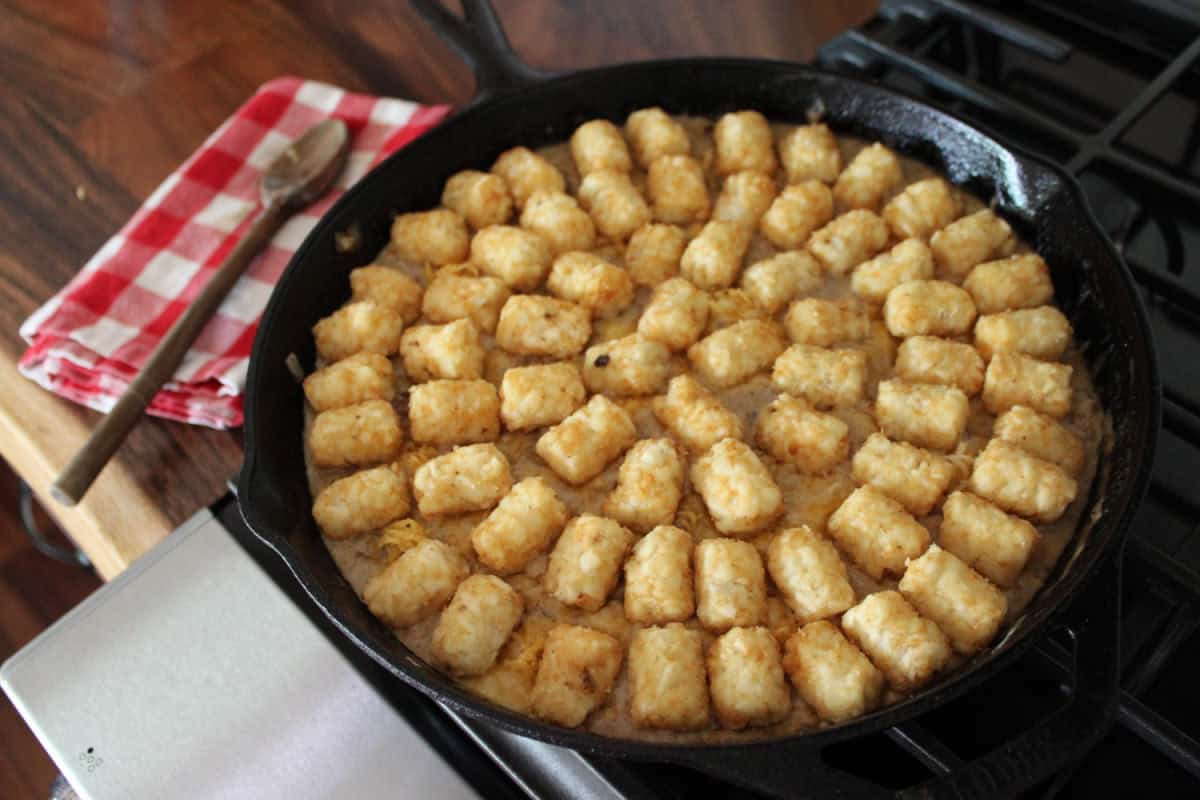 tater tot topping on a cowboy casserole skillet