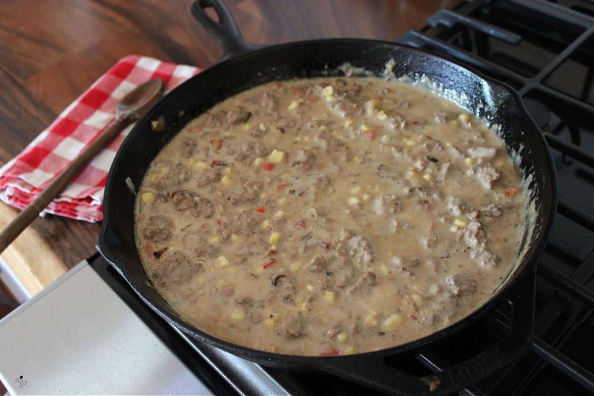 cast iron skillet filled with a creamy meat mixture