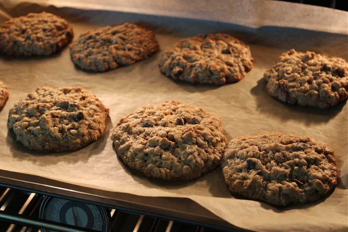 sourdough cowboy cookies in the oven on a cookie sheet