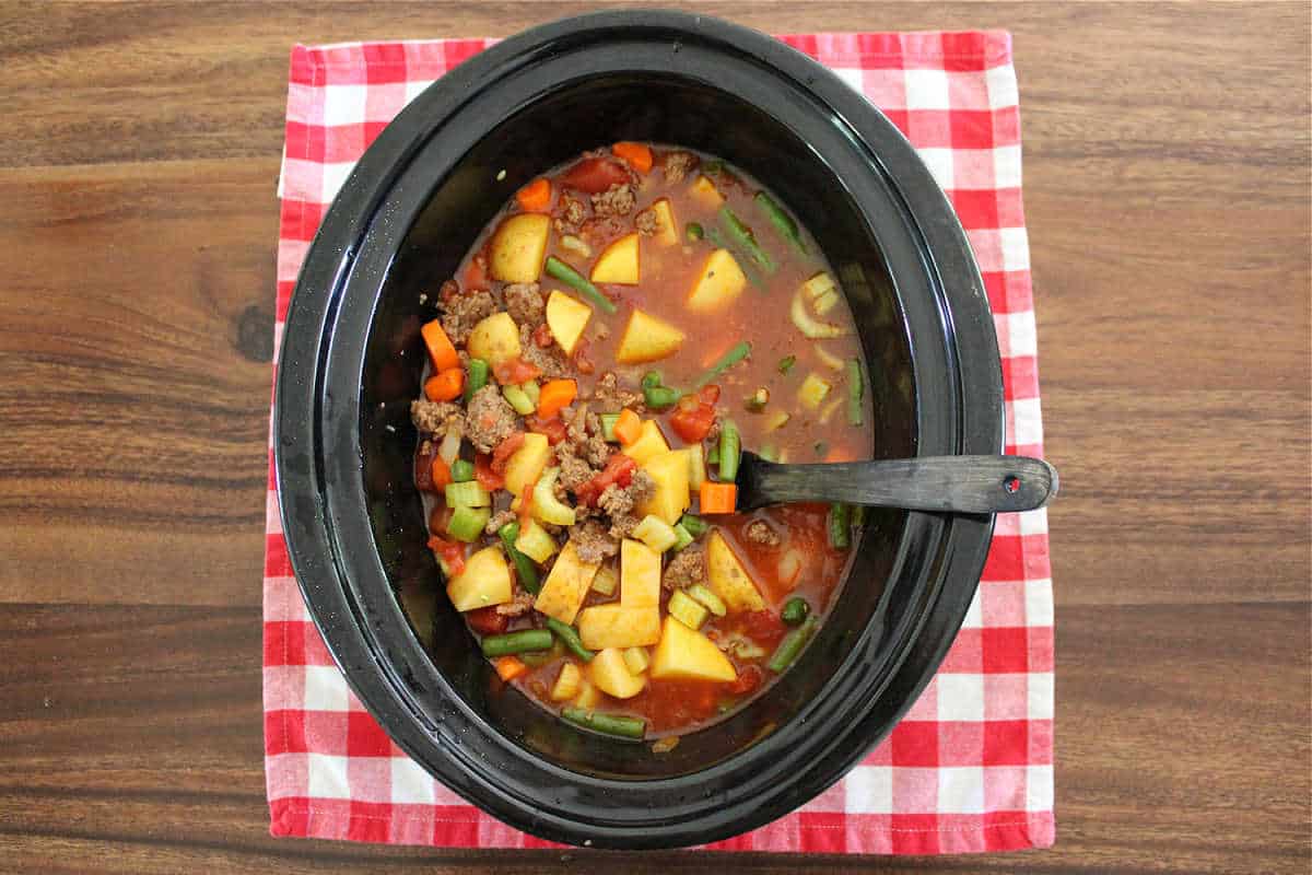 over head shot of Slow Cooker poor man’s stew in a black slow cooker with the lid off.