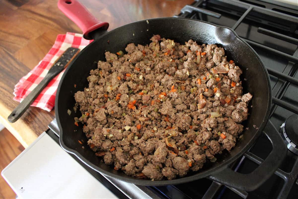 browned ground venison in a black cast iron skillet