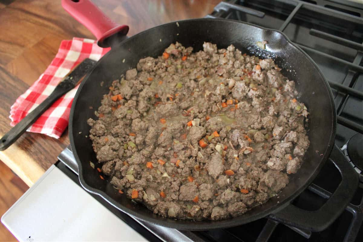 browned ground venison in a black cast iron