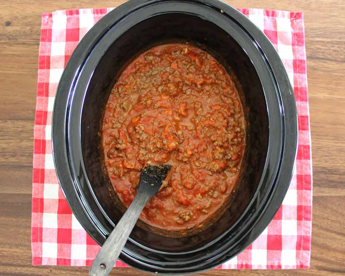 marinara and ground venison mixed together in a black slow cook
