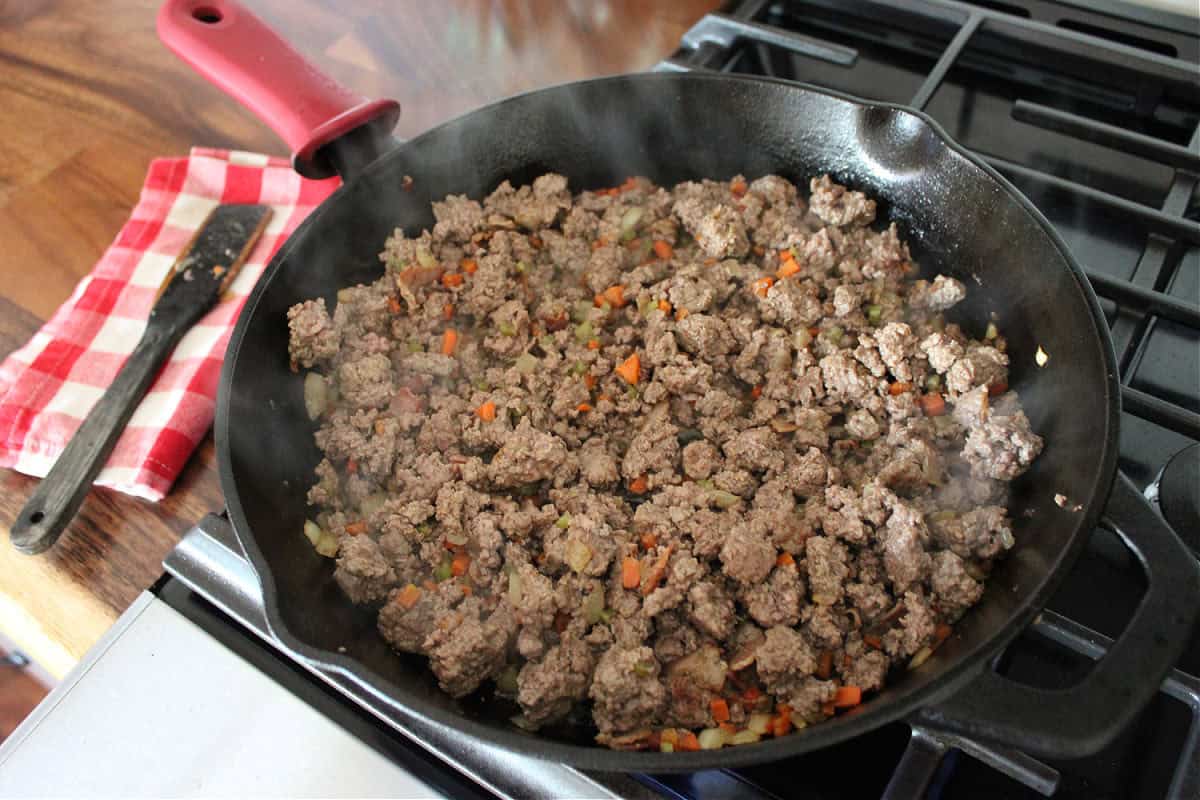 browned ground venison in a black cast iron skillet