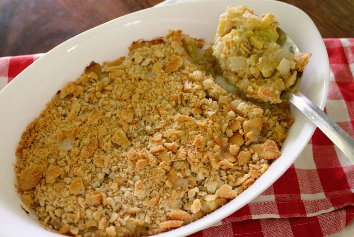 yellow squash casserole in a white casserole dish