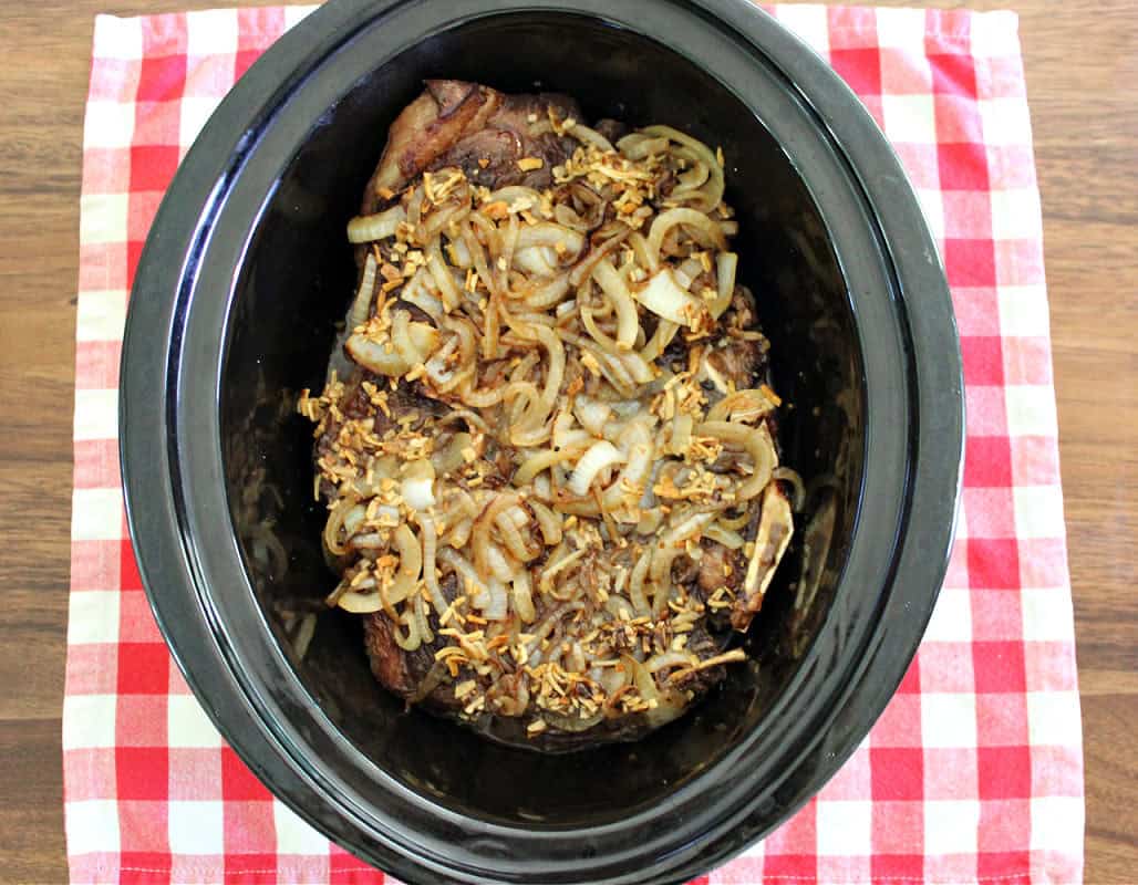 overhead shot of french onion pot roast in the slow cooker