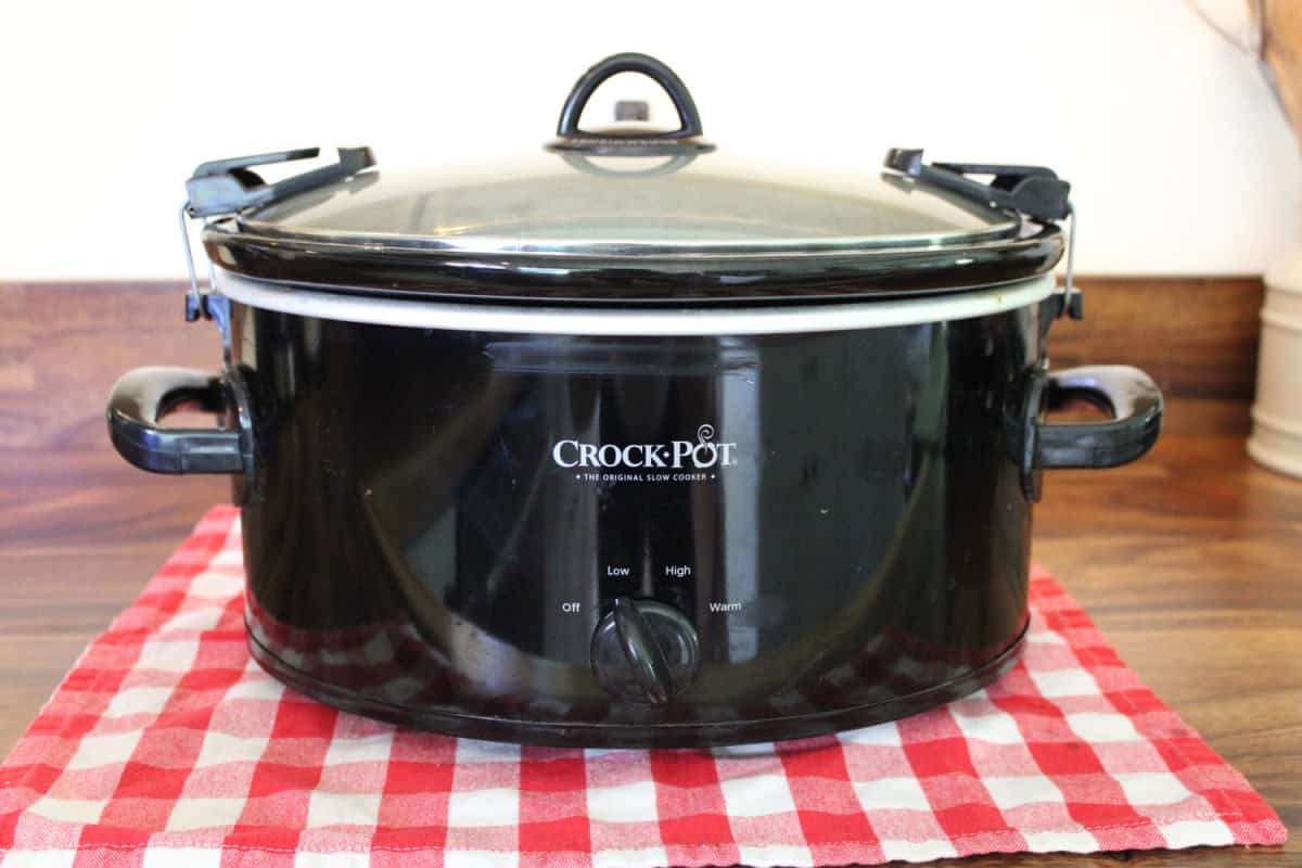 black slow cooker on wood countertop